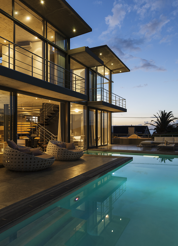 Modern house with pool at sunset.